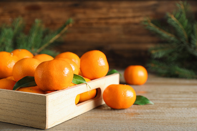 Tasty fresh tangerines on wooden table. Christmas celebration