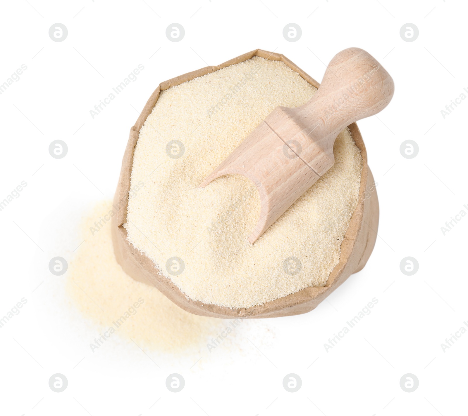 Photo of Uncooked organic semolina in paper bag and scoop isolated on white, top view