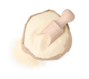 Photo of Uncooked organic semolina in paper bag and scoop isolated on white, top view