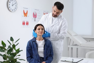 Photo of Endocrinologist examining thyroid gland of patient at hospital