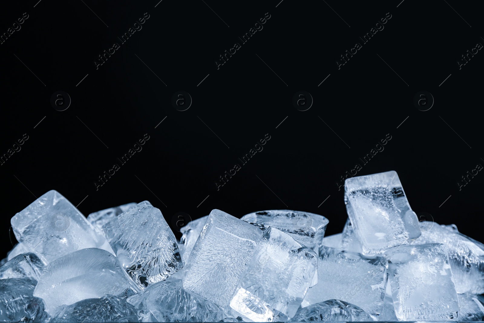 Photo of Ice cubes on black background, closeup view