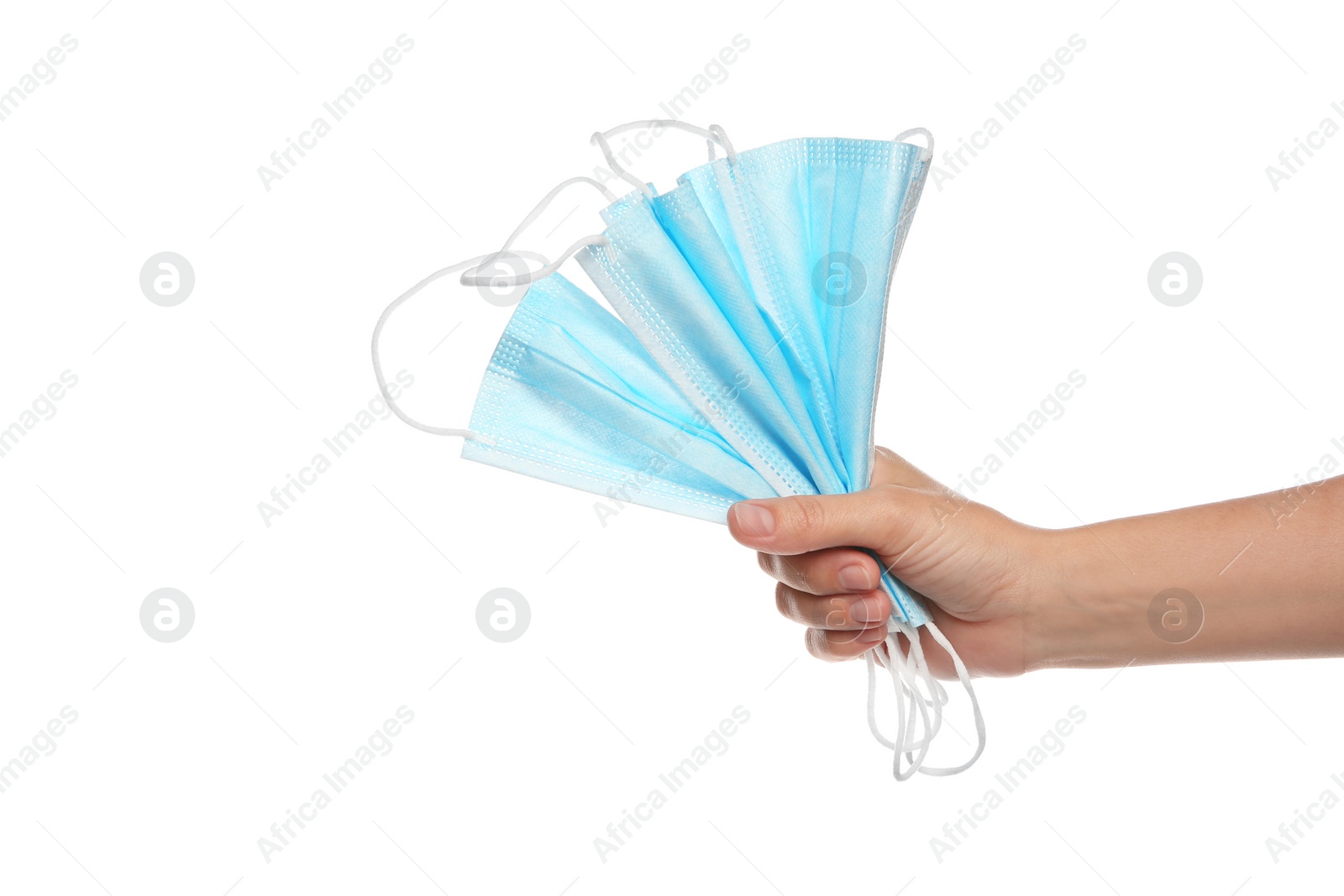 Photo of Woman holding disposable face masks on white background, closeup. Protective measures during coronavirus quarantine