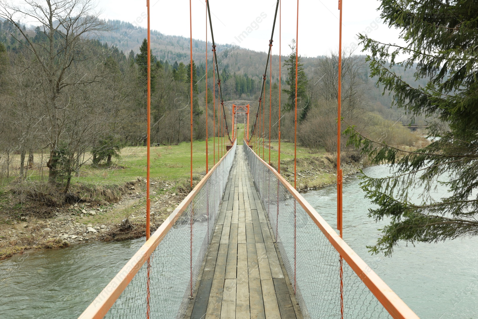 Photo of Crossing river in mountains, view from bridge