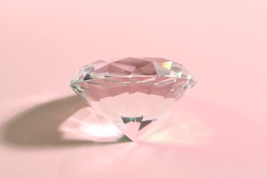 Photo of Big beautiful dazzling diamond on pink background