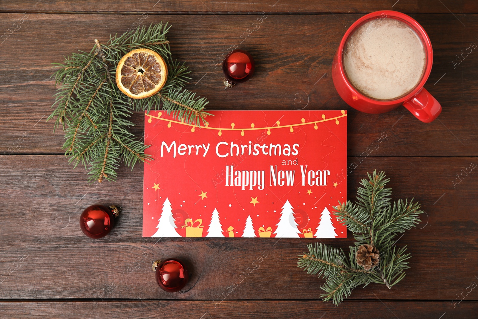 Photo of Flat lay composition with greeting card and Christmas decor on wooden background