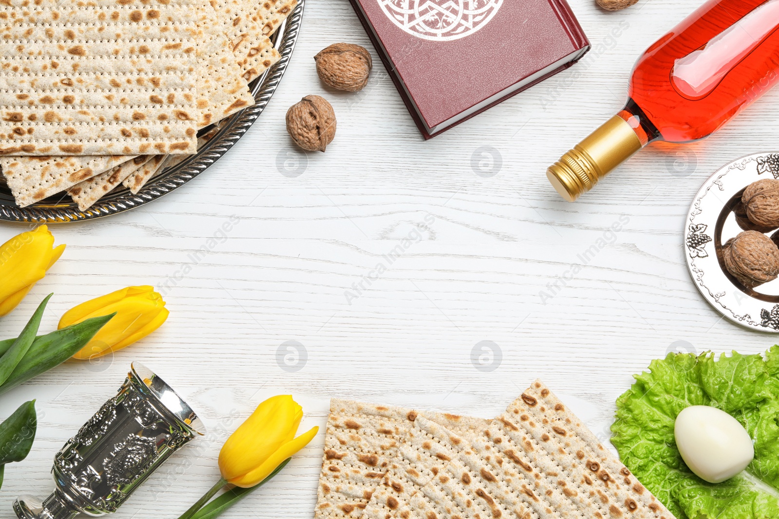 Photo of Flat lay composition with symbolic Passover (Pesach) items on wooden background, space for text