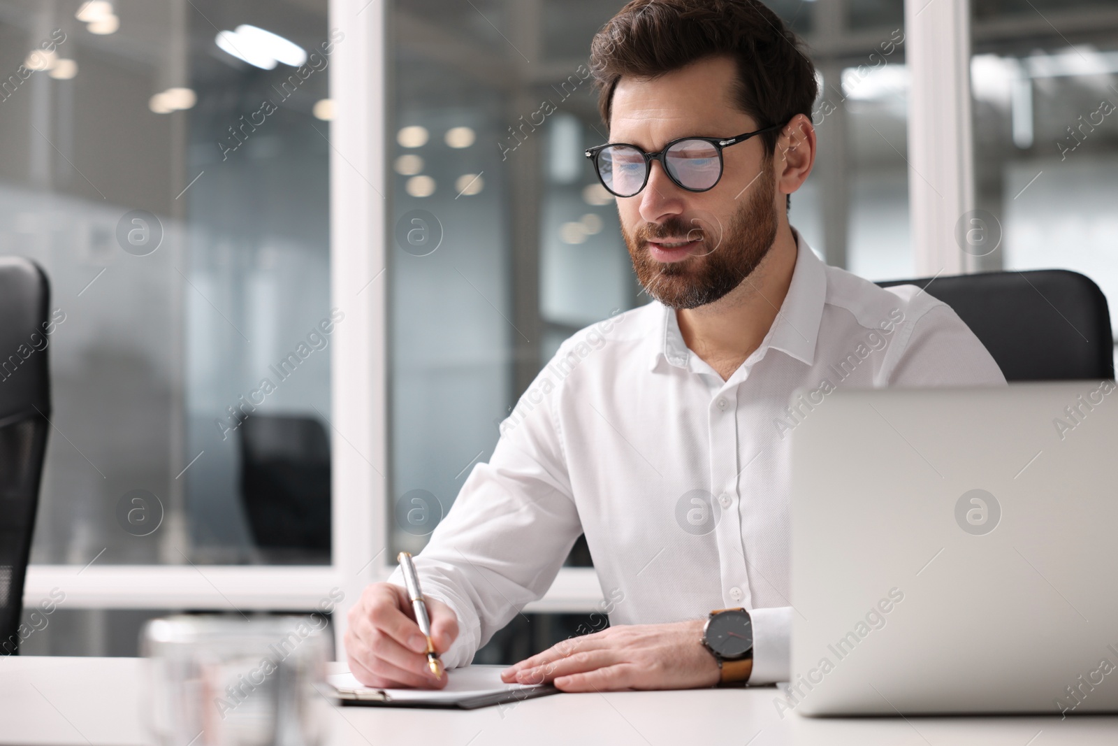 Photo of Serious man working in office, space for text. Lawyer, businessman, accountant or manager