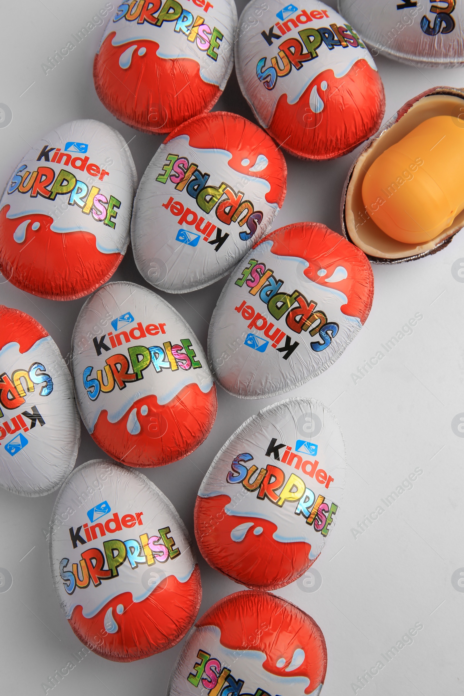 Photo of Sveti Vlas, Bulgaria - June 26, 2023: Kinder Surprise Eggs and plastic capsule with toy on white background, flat lay