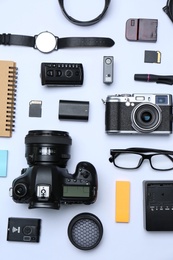 Photo of Flat lay composition with equipment for professional photographer on white background