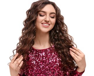Beautiful young woman with long curly brown hair in pink sequin dress on white background