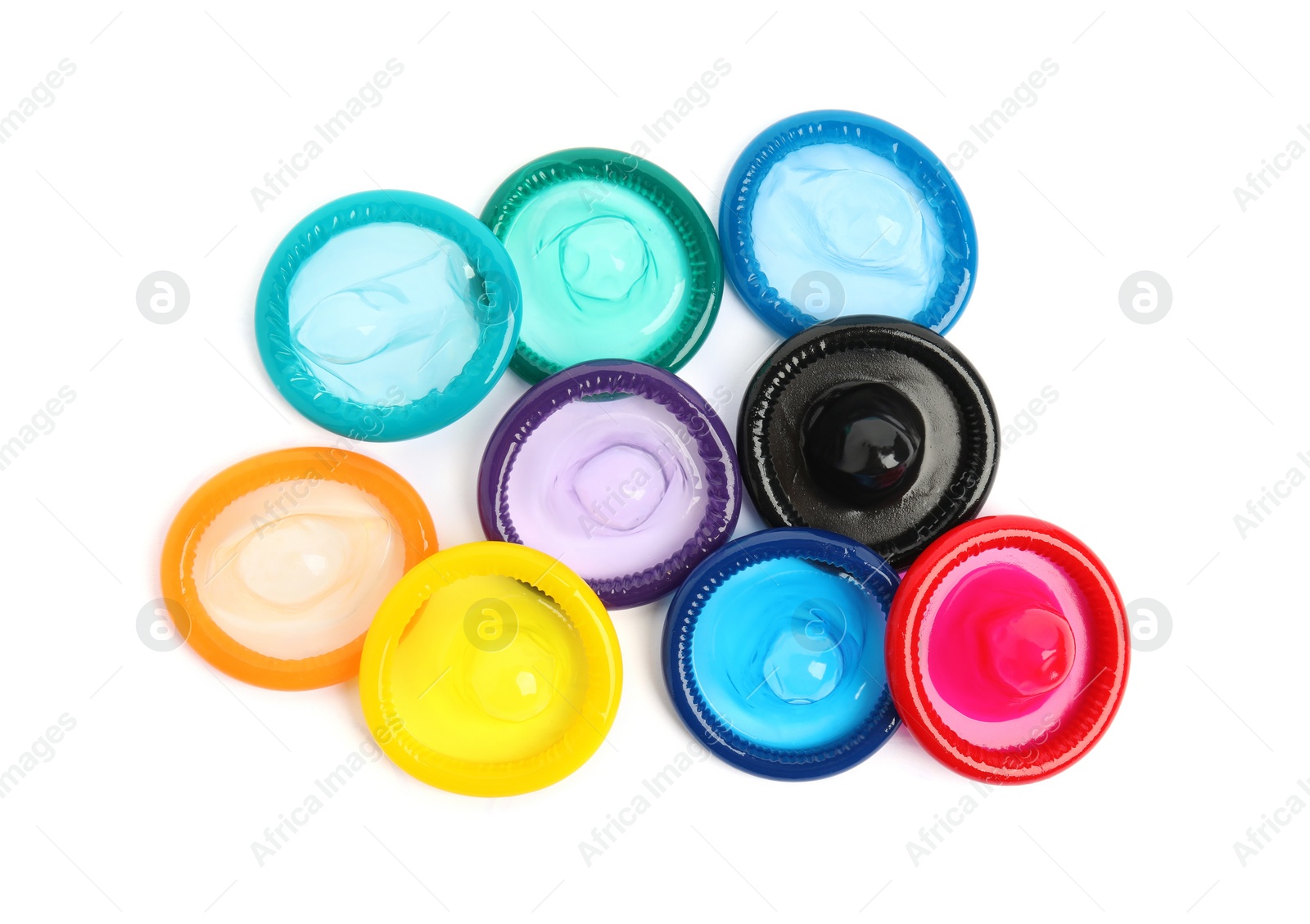 Photo of Unpacked colorful condoms on white background, top view. Safe sex