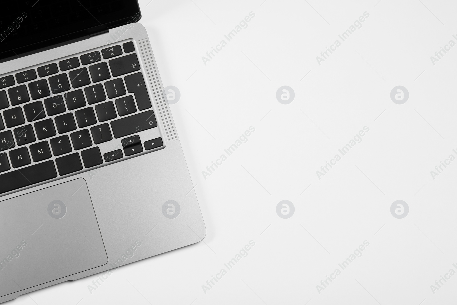 Photo of Modern laptop on white background, top view. Space for text