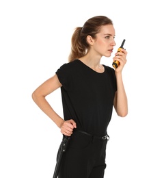 Female security guard in uniform using portable radio transmitter on white background