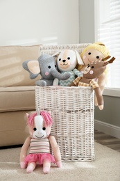 Photo of Funny stuffed toys and basket in children's room. Interior decor