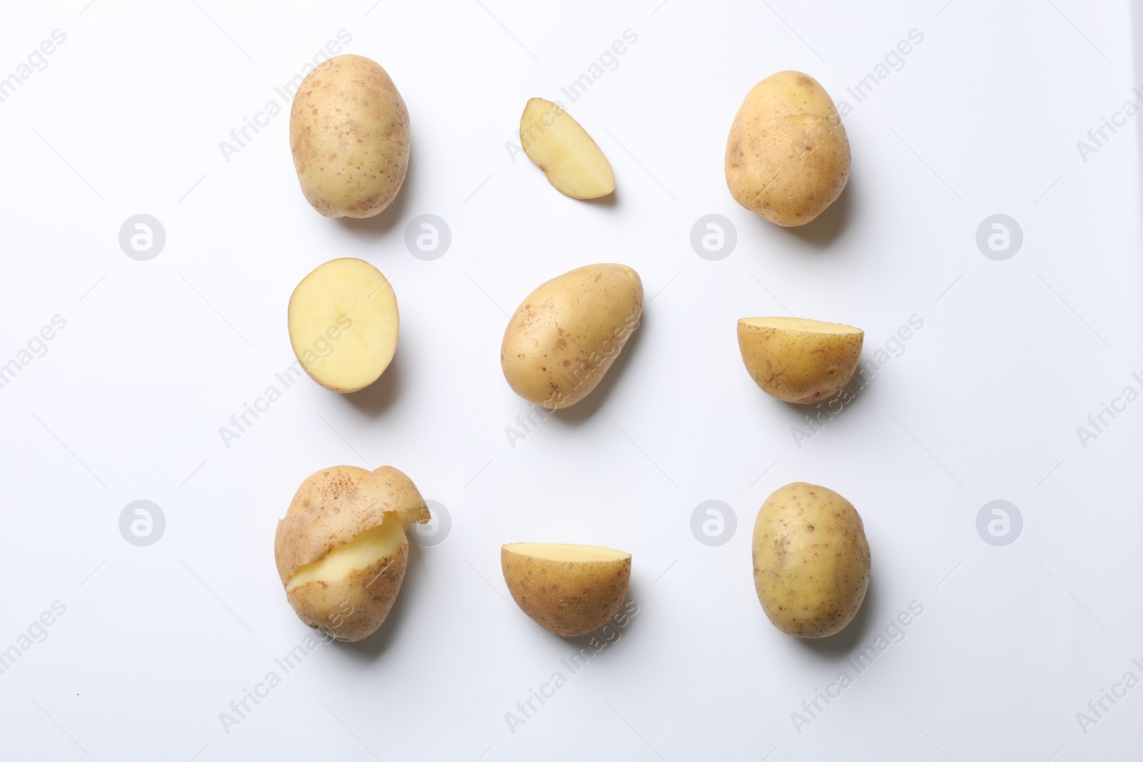 Photo of Fresh raw potatoes on white background, flat lay