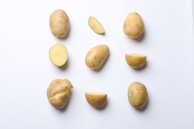 Photo of Fresh raw potatoes on white background, flat lay