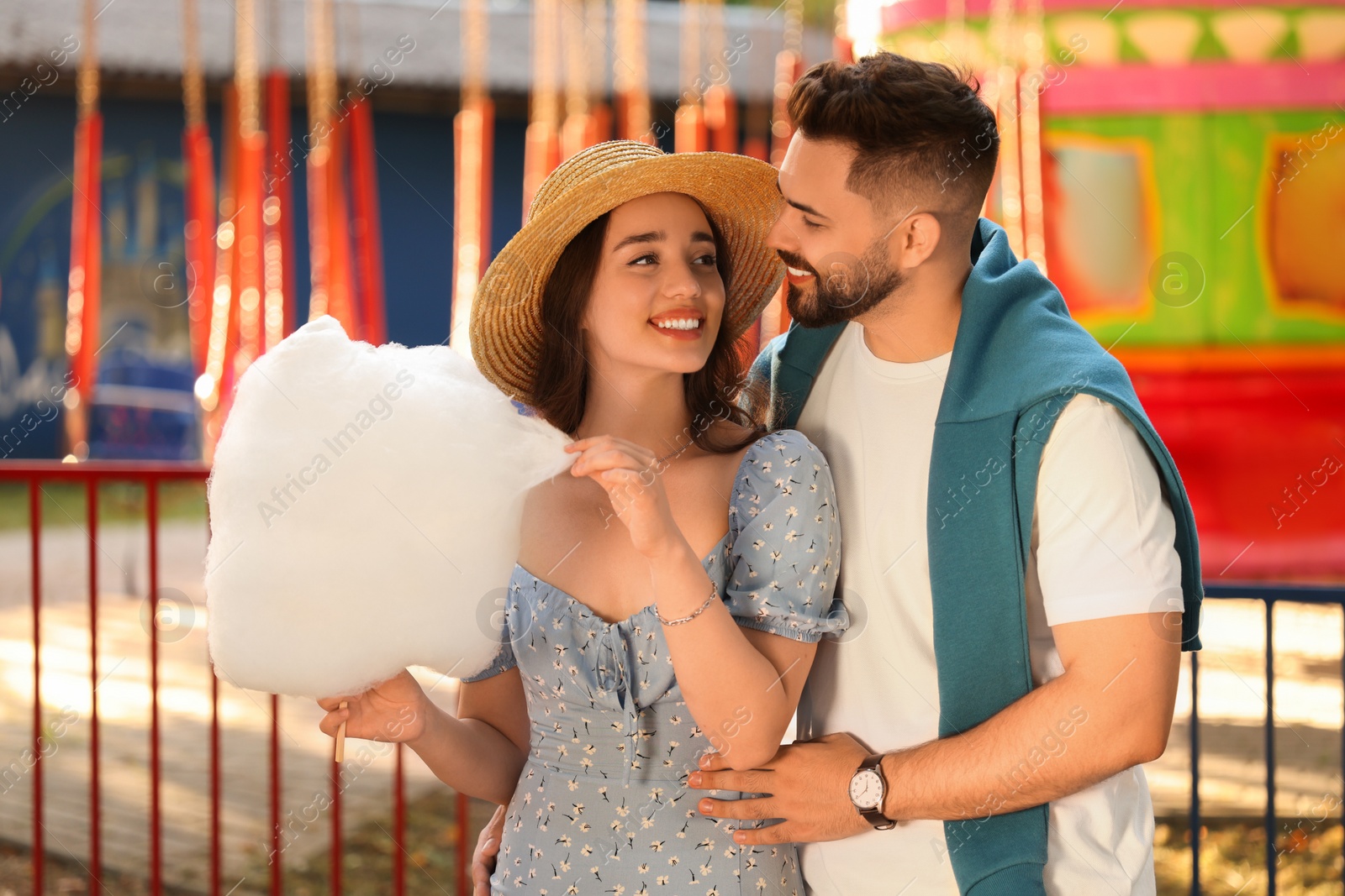 Photo of Happy couple with cotton candy at funfair