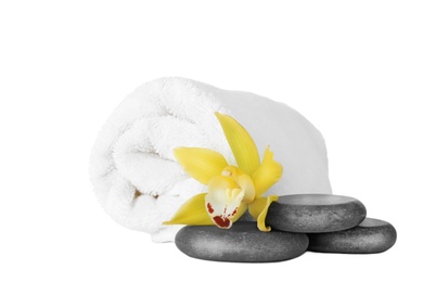 Photo of Fresh towel, spa stones and exotic flower isolated on white