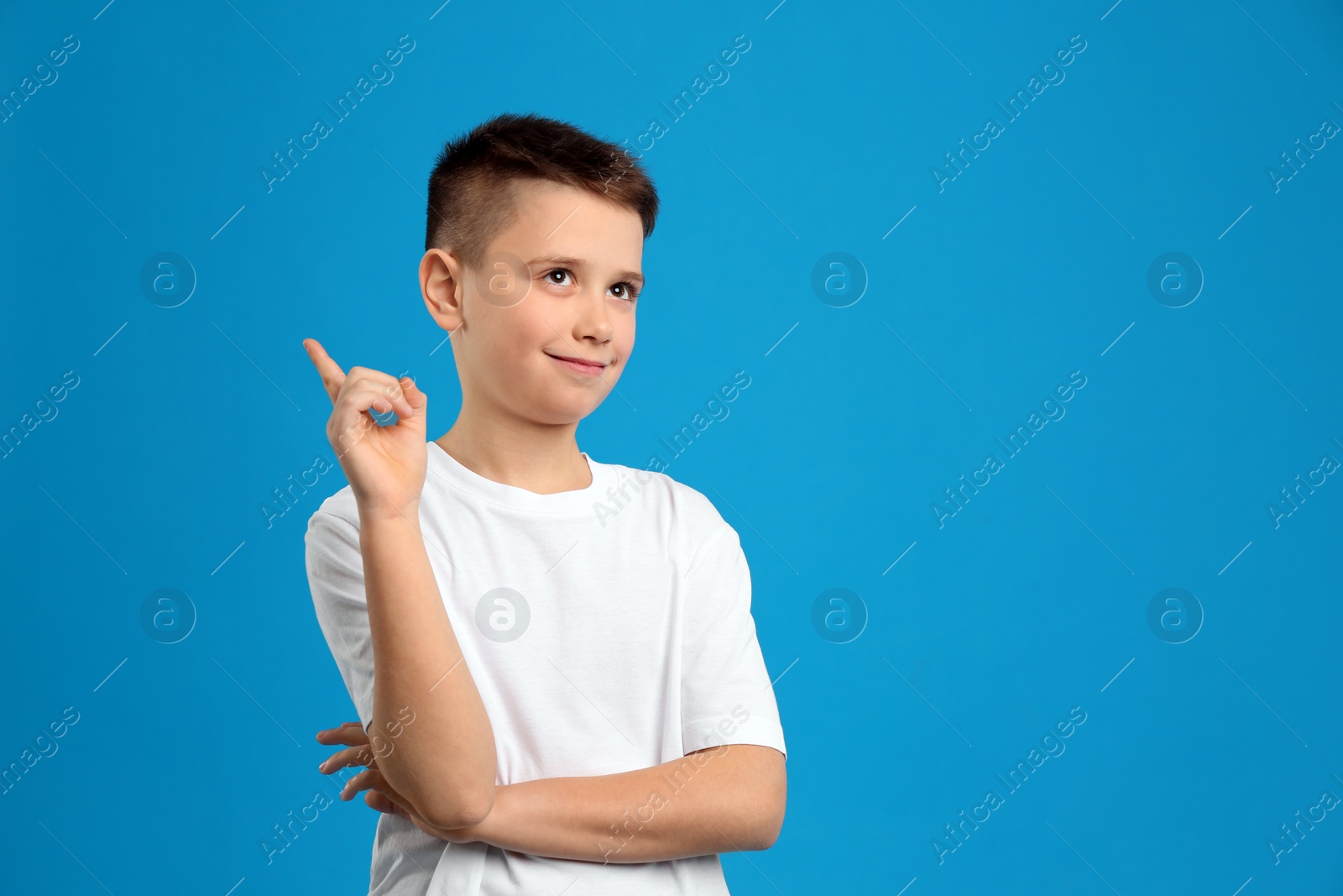 Photo of Portrait of preteen boy on light blue background, space for text