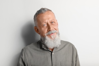 Portrait of handsome senior man on white background