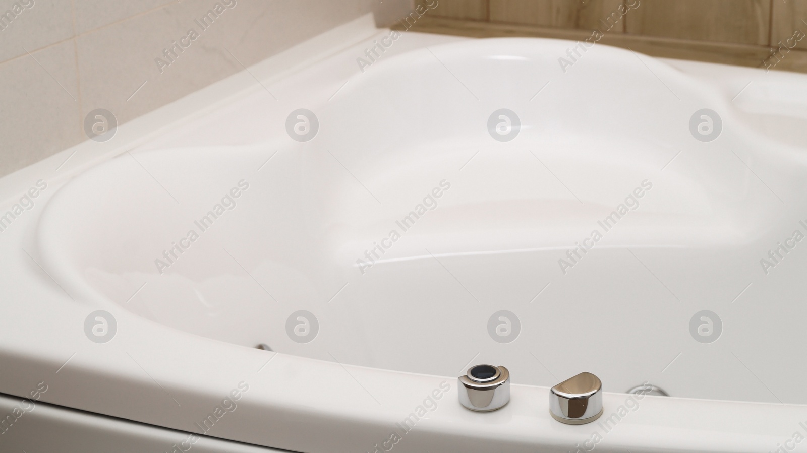 Photo of Closeup view of hot tub with buttons indoors