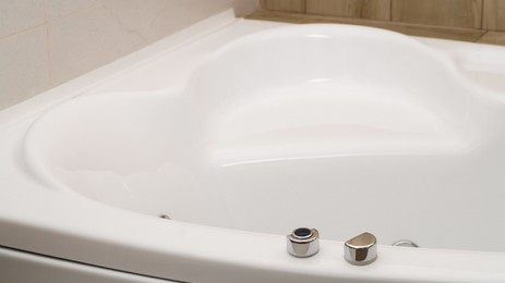 Closeup view of hot tub with buttons indoors