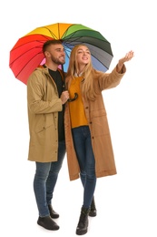 Full length portrait of beautiful couple with umbrella, isolated on white