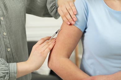 Photo of Diabetes. Woman getting insulin injection indoors, closeup