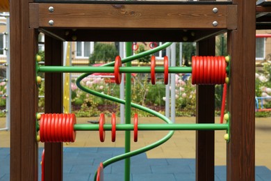 Photo of Colourful abacus on outdoor playground in residential area