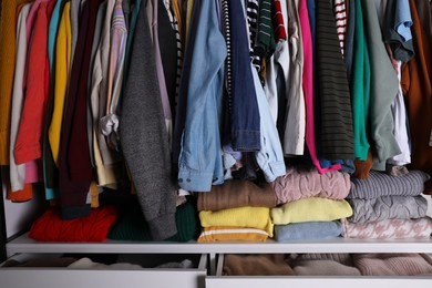 Photo of Wardrobe closet with different stylish clothes. Fast fashion