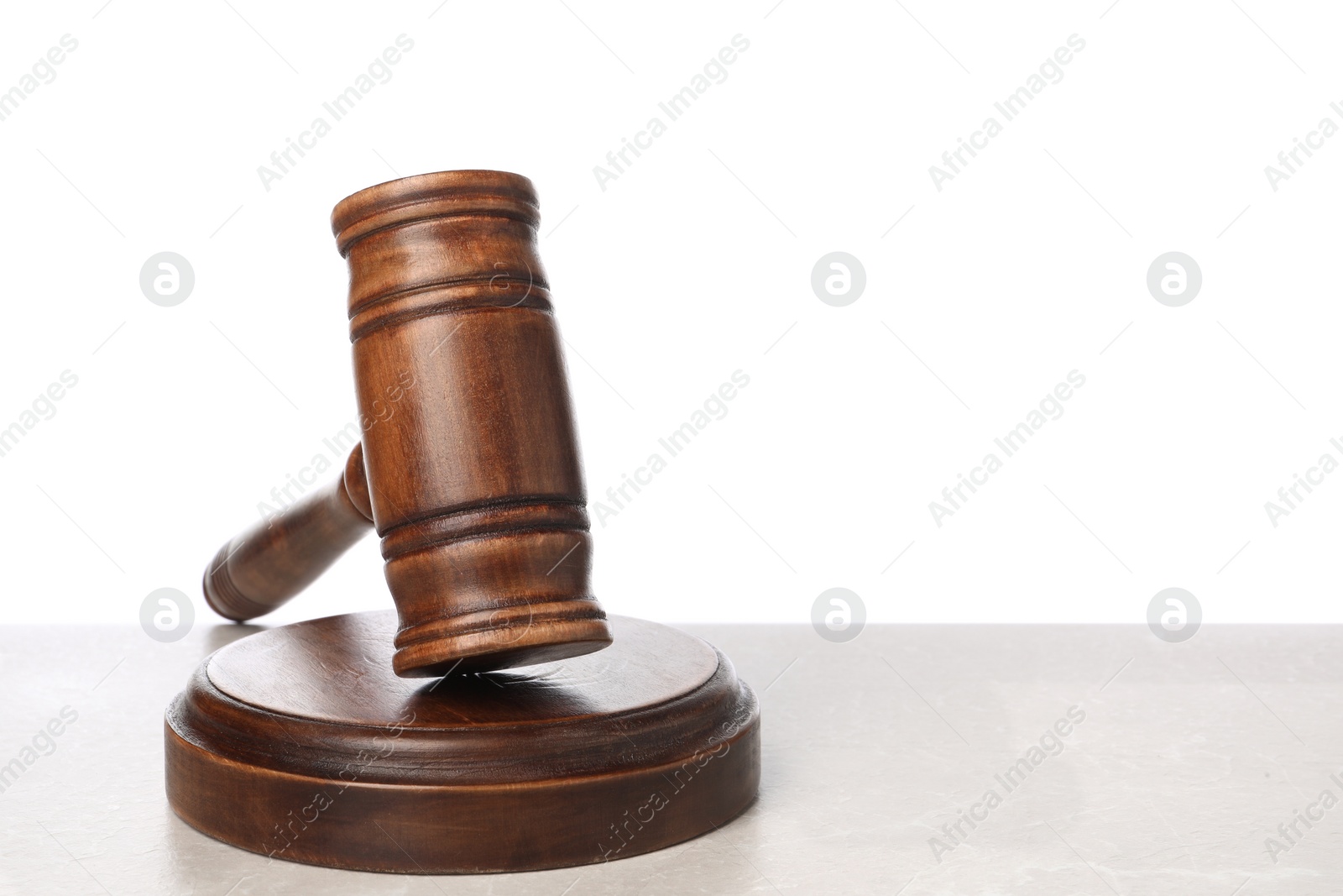 Photo of Wooden gavel on light table against white background. Space for text