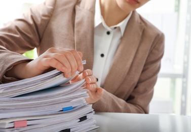 Woman working with documents in office, closeup