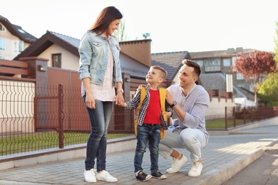 Photo of Young woman taking their little child to school