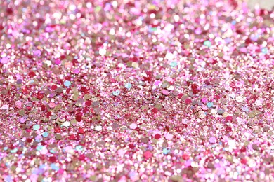 Photo of Beautiful pink shiny glitter as background, closeup