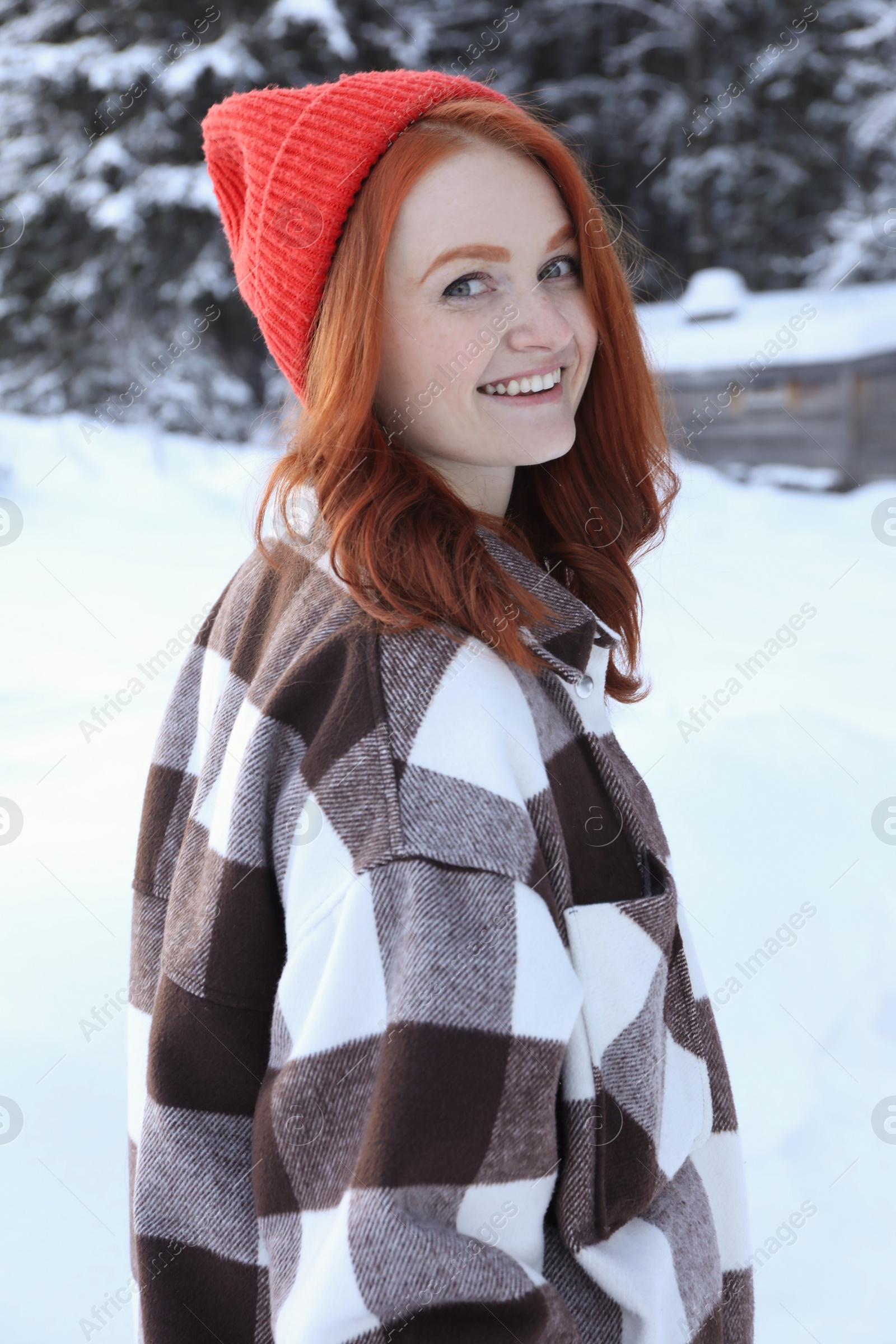 Photo of Portrait of beautiful young woman on snowy day outdoors. Winter vacation