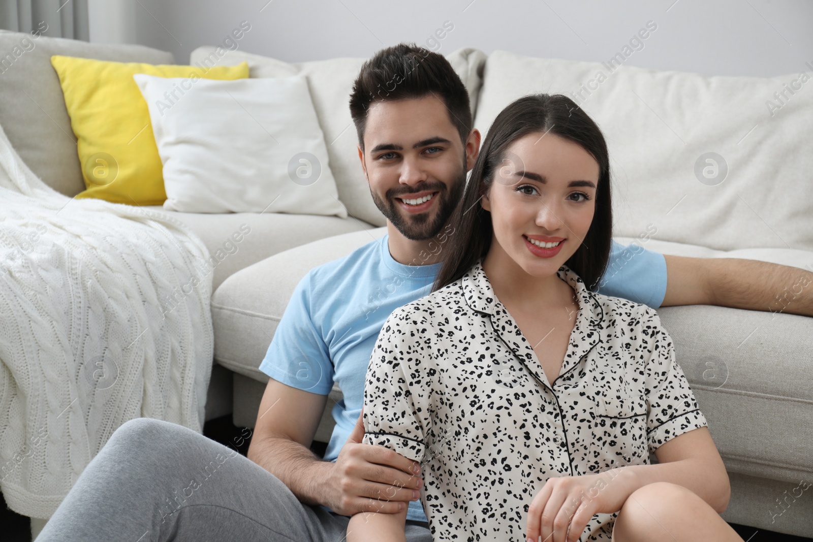 Photo of Happy young couple in pajamas at home