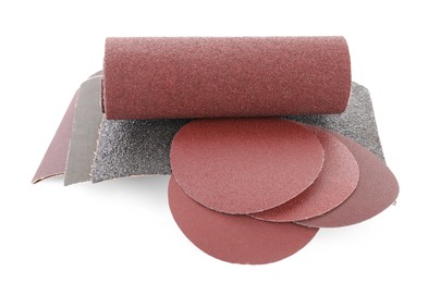 Photo of Many sheets of sandpaper isolated on white