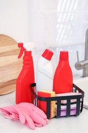 Different cleaning supplies on counter in kitchen