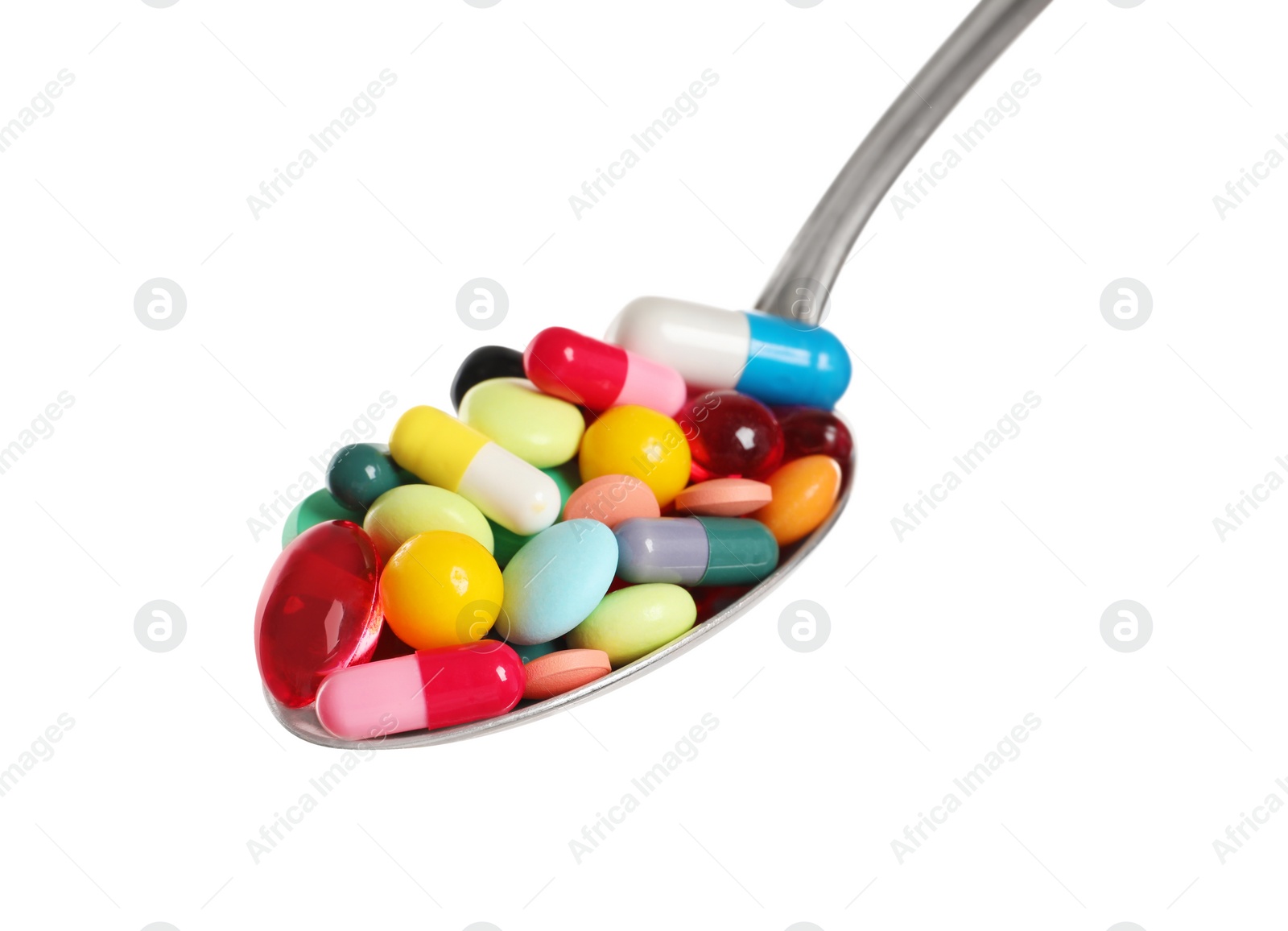 Photo of Different colorful pills in spoon isolated on white