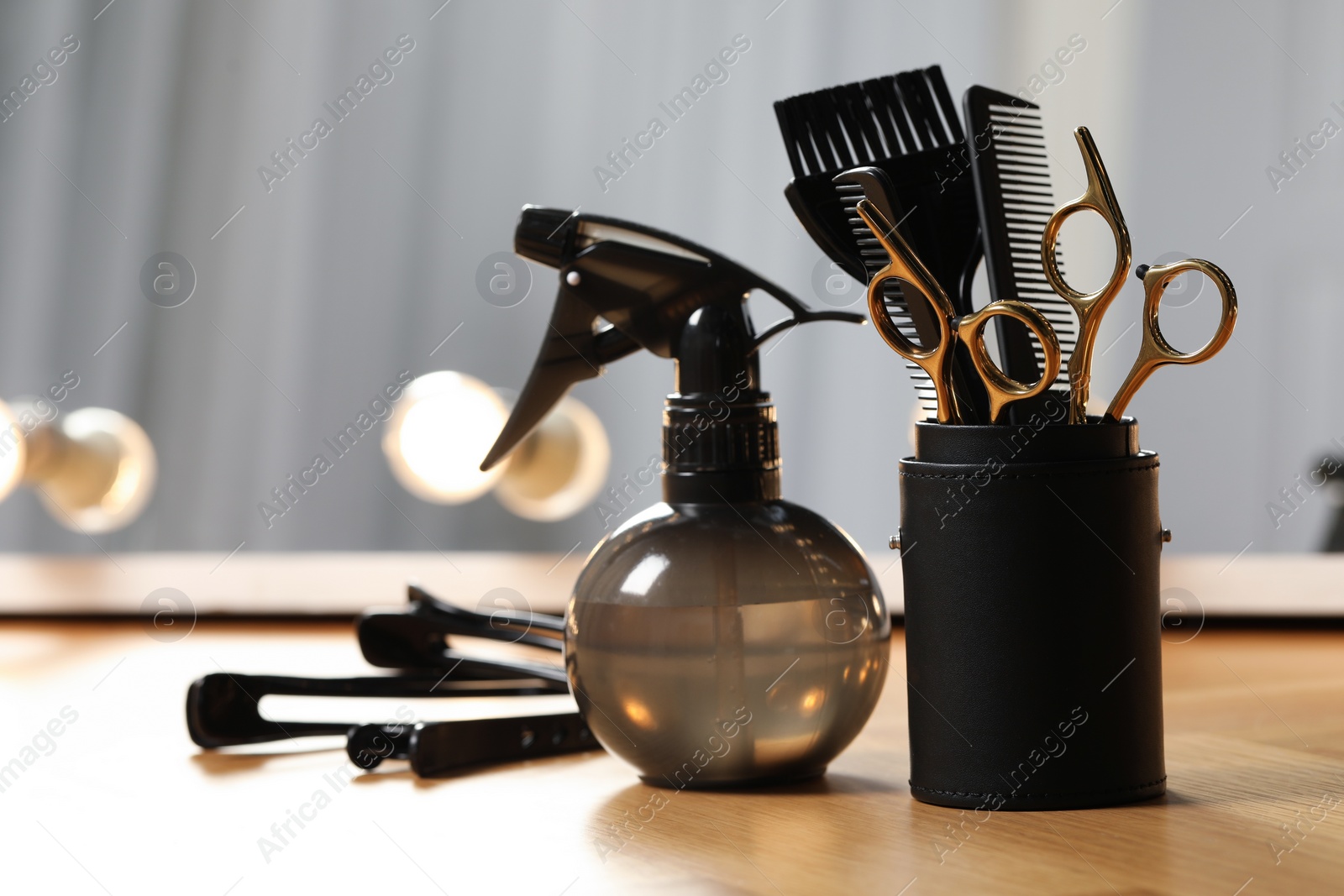 Photo of Set of hairdresser tools on table in salon, space for text