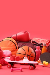 Photo of Many different sports equipment on red background, space for text