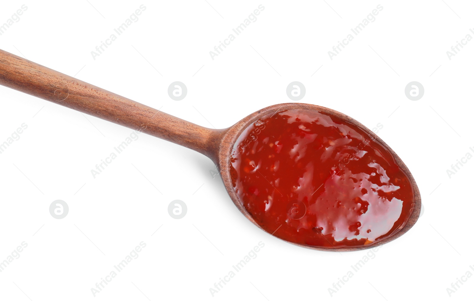 Photo of Spicy chili sauce in spoon isolated on white, top view