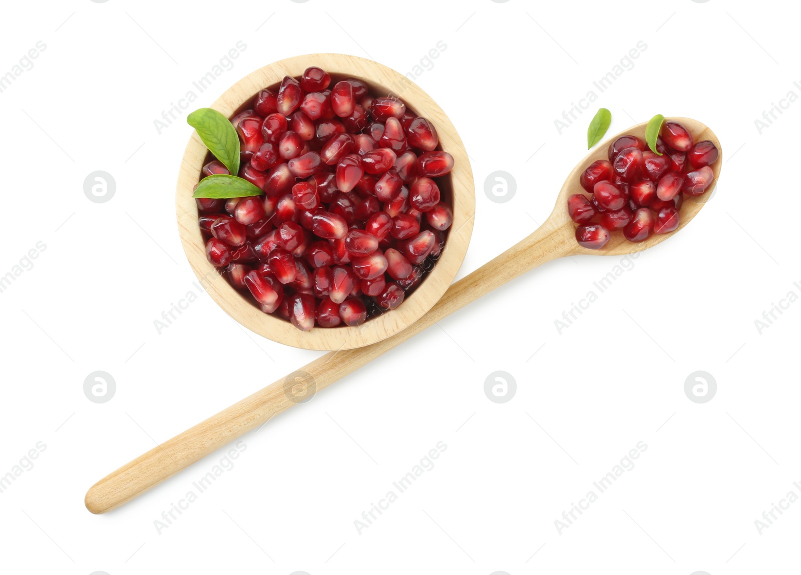 Photo of Ripe juicy pomegranate grains in bowl and wooden spoon isolated on white, top view