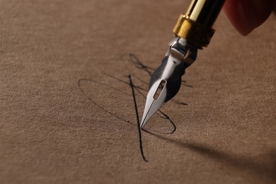 Woman signing on sheet of paper with fountain pen, closeup. Space for text