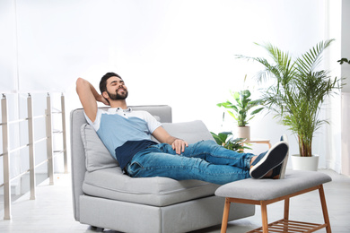 Young man relaxing on couch at home