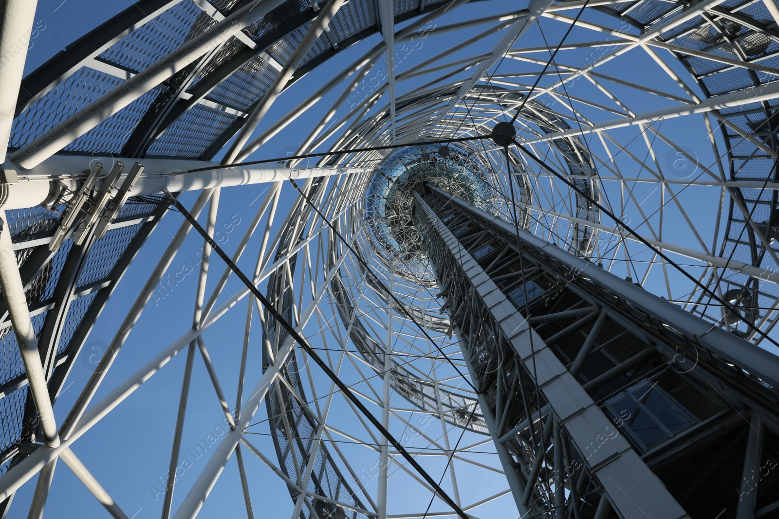 Photo of Structure of modern tower against blue sky, bottom view