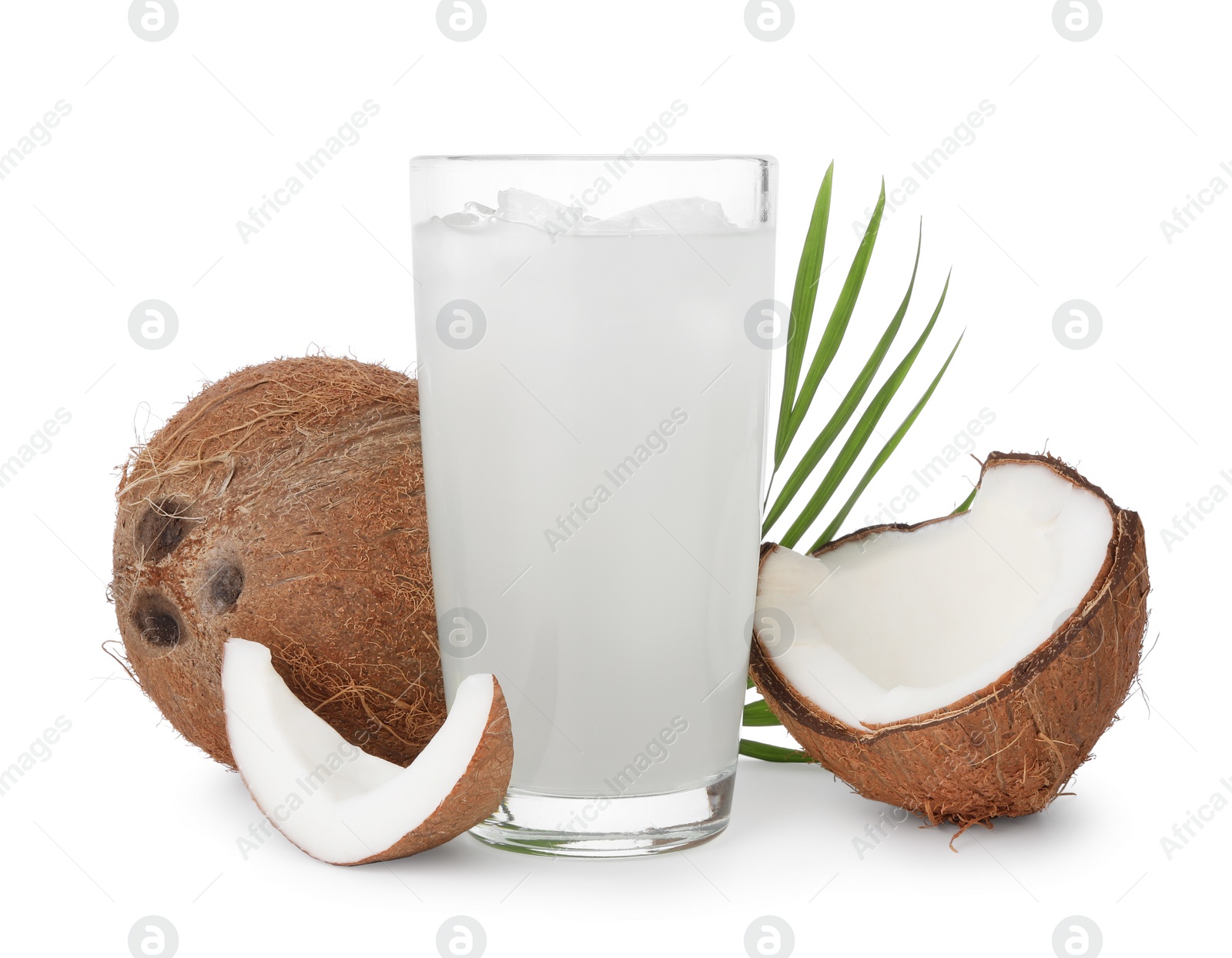 Photo of Glass of coconut water, leaf, ice cubes and nuts isolated on white