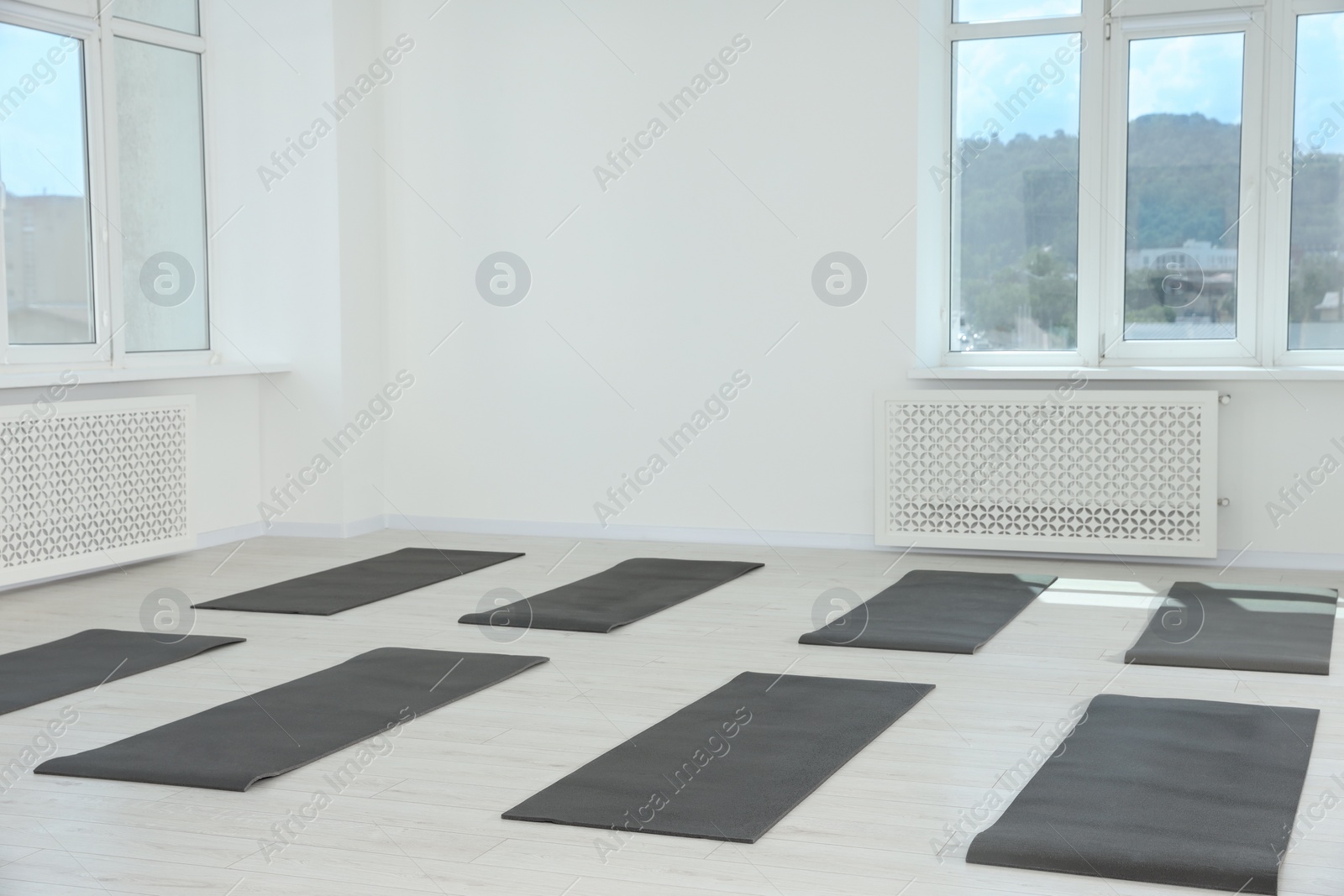 Photo of Spacious yoga studio with exercise mats and big windows