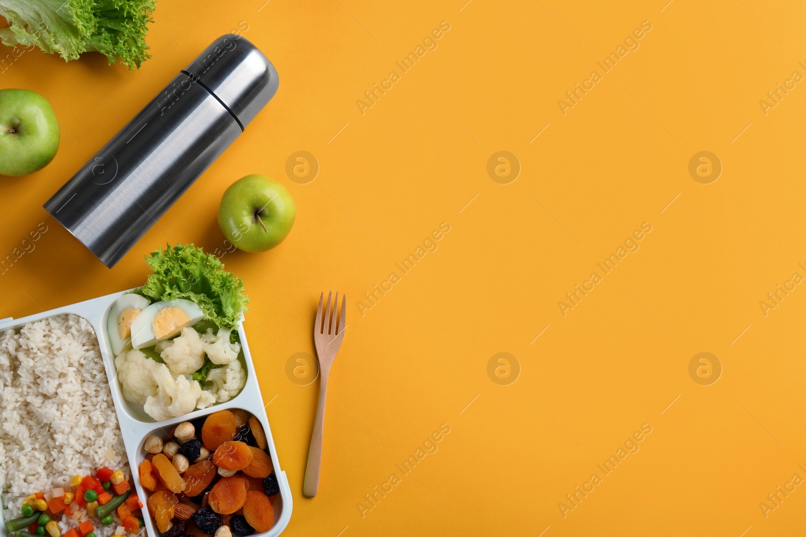 Photo of Flat lay composition with thermos on orange background. Space for text