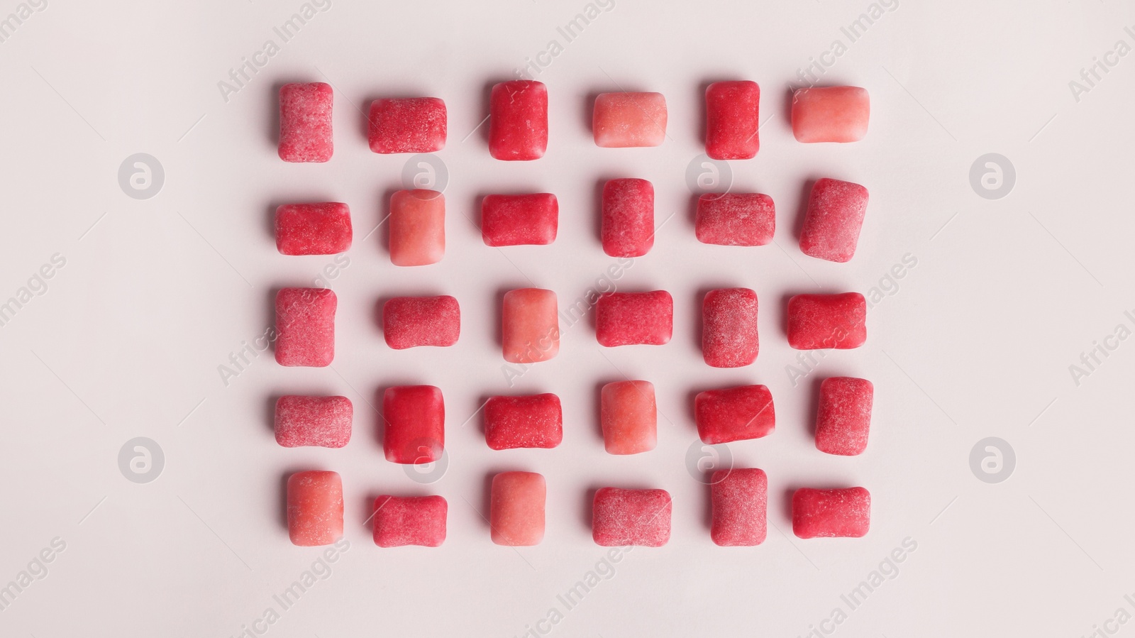 Photo of Sweet chewing gums on white background, top view